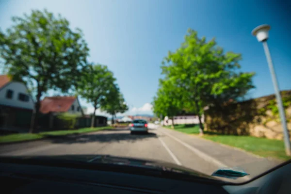 Uitzicht vanaf de auto bij het silhouet van auto, huizen en boom — Stockfoto
