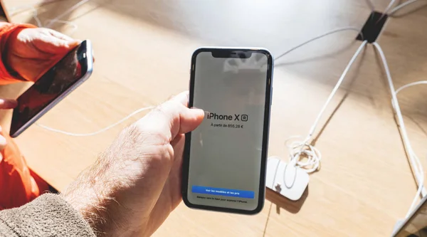 Man and woman hands holding latest iPhone XR smartphone — Stock Photo, Image