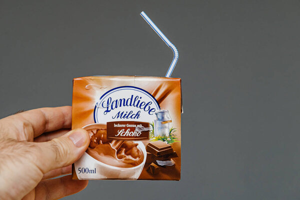 Man hand holding Landliebe Milch milk