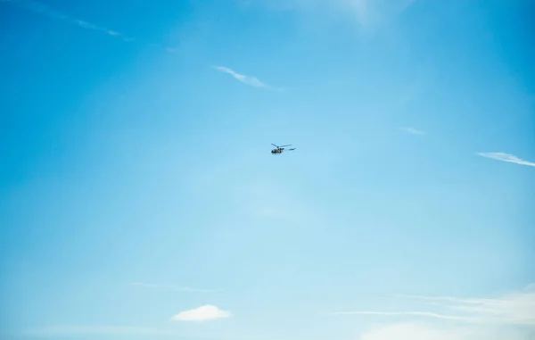 Blue sky with small helicopter flying — Stock Photo, Image