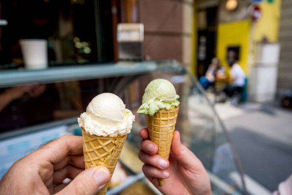 man and woman holding in hands ice cream parlor