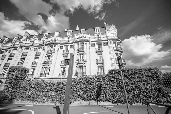 Black and white image of low wide angle view of Parisian propert