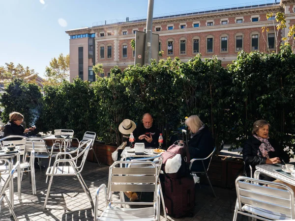 Group of seniors drinking coffee eating smoking at the terrace — Stock Photo, Image