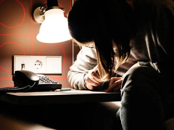 Close-up image woman writing a letter near bed — Stock Photo, Image