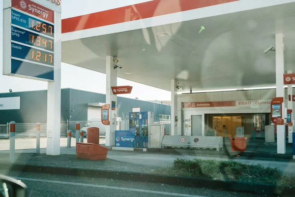 Esso gas station seen through car window with gas prices — Stock Photo, Image