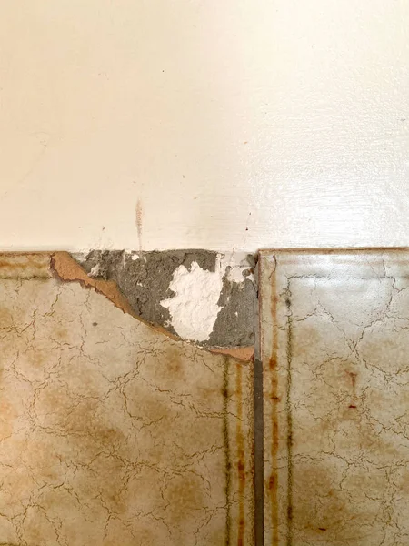Damaged vintage tile corner on the wall