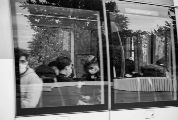 Defocused view of people silhouettes inside tramway wearing protective masks — Stock Photo, Image