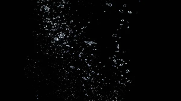 Close-up images of soda water splashing in the water to many little bubbles that make it feel like refreshing and black background