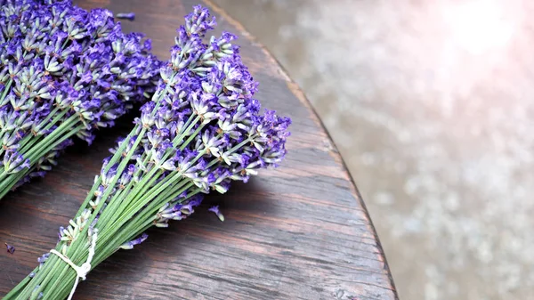 Lavender bouquet on wood table top view angle at Furano Hokkaido Japan which flowers are full bloom and have a great fragrance of aroma for relaxing moment.