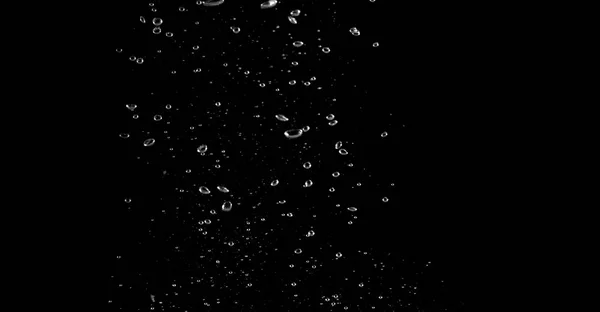Obrazy rozmyte soda pęcherzyki rozpryskiwania w czarnym tle — Zdjęcie stockowe