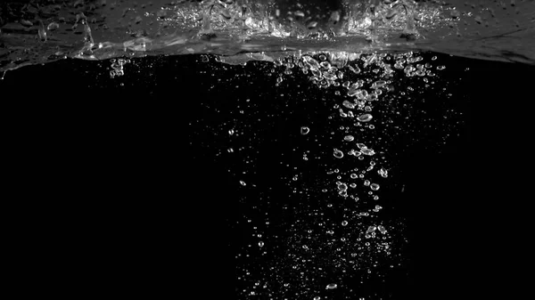 Blurry images of soda bubbles splashing in black background