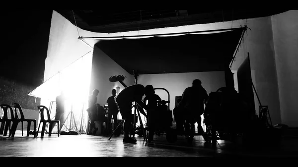 Behind the shooting production crew team and silhouette of camer — Stockfoto