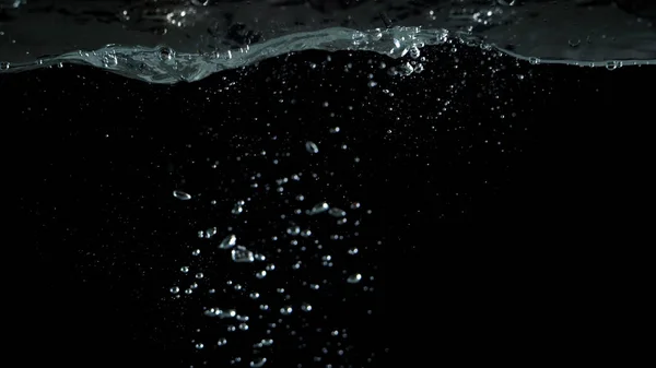 Elmosódott képek pezsgő víz folyékony buborékok fröccsenő — Stock Fotó