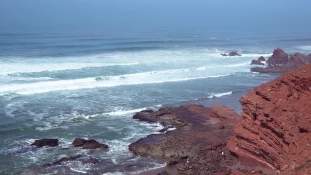 Perfect waves are breaking in front of the rocky shore of the desert of Morocco - Atlantic Ocean Africa — Stock Video