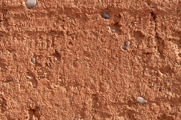 clay earthen wall texture background red - stock image