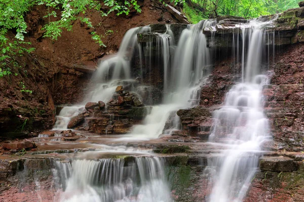 Mountain river waterfall landscape. Cascade of Dzhurynskyi waterfall.