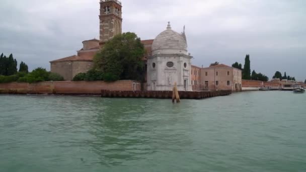 Boote schwimmen auf einem der vielen kanäle in venedig italien, während touristen durch die engen gassen streifen — Stockvideo
