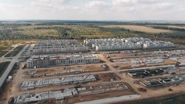 Construction of residential buildings. Construction site from a height. Aerial view construction site. Work of special equipment. Aerial view of the construction site. Aerial view of the buildings. — Stock Video