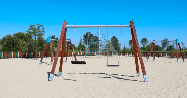 Black Plastic Two Swings Shadow Earth Sand Ground Swinging Urban — Stock Video