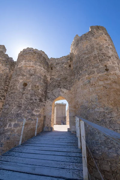 front door and access footbridge of castle in Penaranda de Duero village, landmark and public monument from eleventh century, in Burgos, Castile and Leon, Spain, Europe. Vertical shot