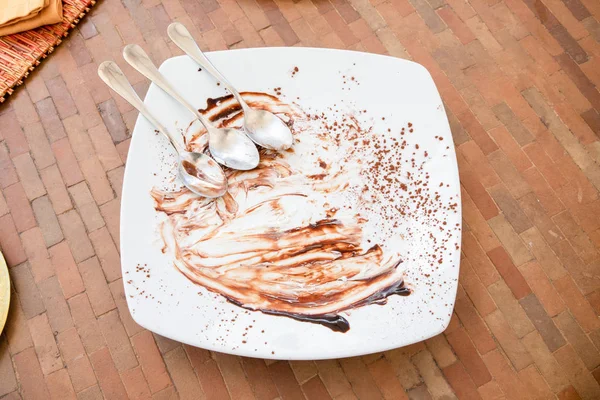 Above of three spoons together on empty and dirty white dish aft — Stock Photo, Image