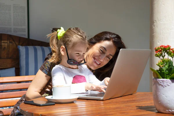 Vicces kislány és az anya nevetve gépelés-ra laptop Jogdíjmentes Stock Fotók