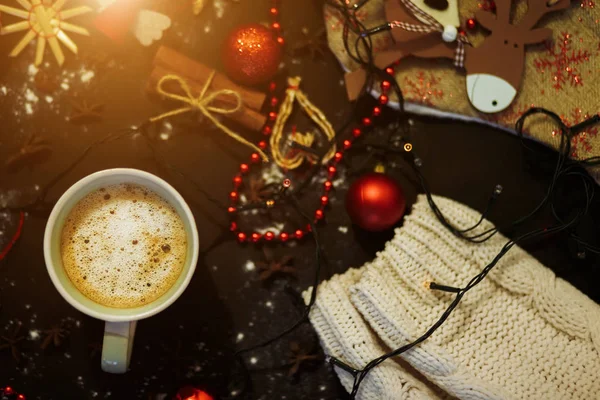 Top view Cup of coffee or cocoa on a black background with Christmas decorations. Christmas, holiday, celebration, winter cozy concepts.