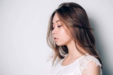 Üzgün kadın kopya alanı ile beyaz bir arka plan üzerinde yana portresi. Negatif insan duygular, yüz ifadeleri.