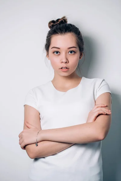 Beautiful confident young business woman on white background looking into the camera