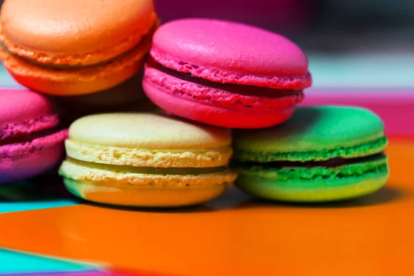 Close up of macro photo of French dessert, fresh colored macaroons on the table