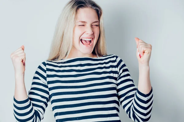 Beautiful happy woman excited expressing winning gesture. Successful and celebrating victory, triumphant on white background. Positive emotions, facial expression, gestures concept