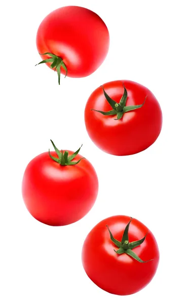 Röda mogna tomater faller ner på vit bakgrund, isolera, närbild — Stockfoto