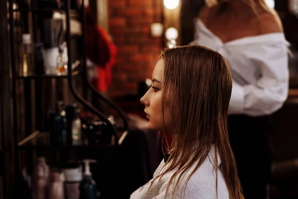 Beautiful woman in hair salon