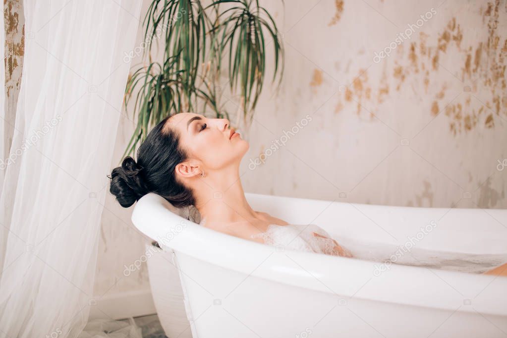 Beautiful sexy woman in bubble bathtub