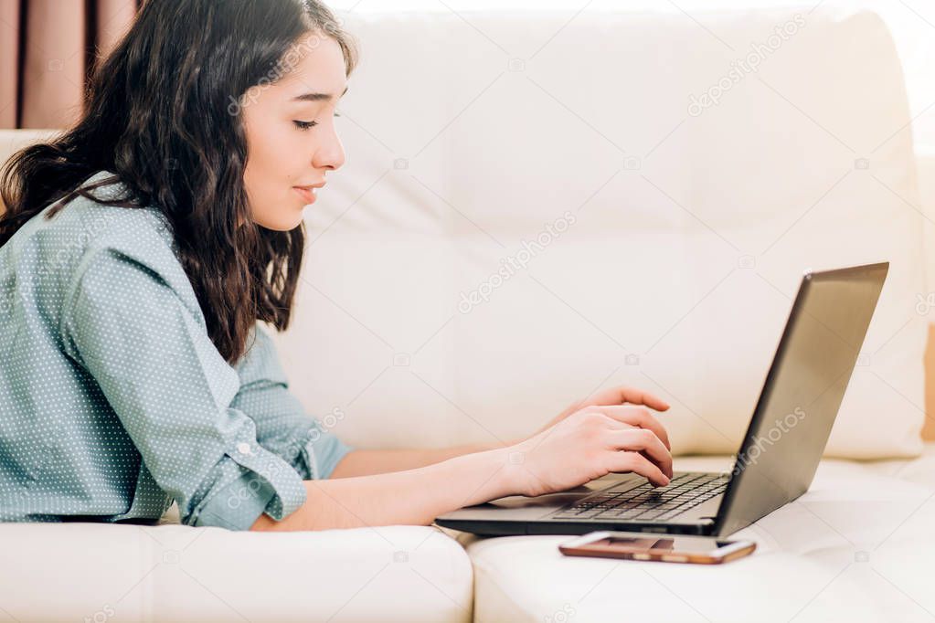 Bbeautiful woman using laptop computer at home on sofa