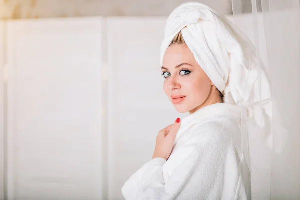 Young smiling woman in bathrobe with towel on head — 스톡 사진