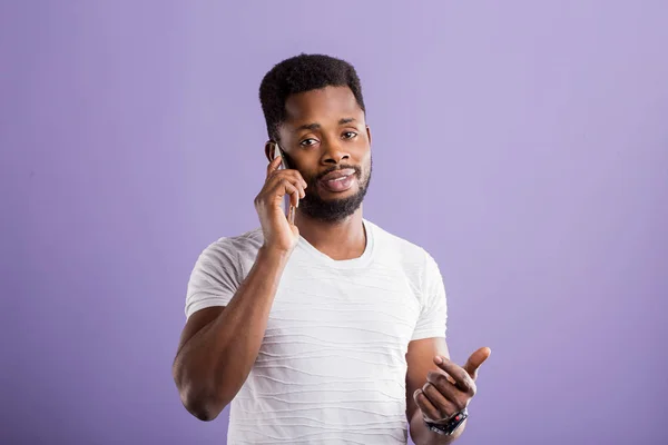 stock image Studio portrait of american man posing with smartphone