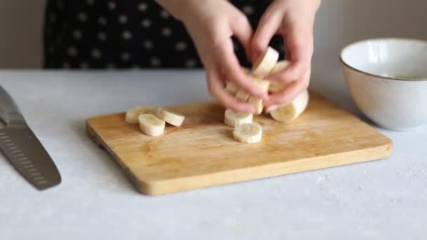 Woman Cuts Banana Knife Wooden Board Kitchen Closeup Healthy Breakfast — 图库视频影像