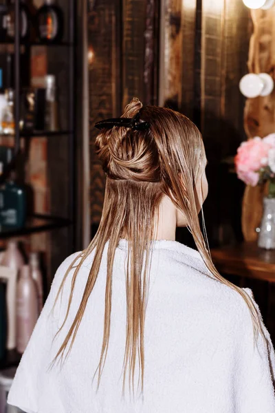 Beautiful woman in hair salon