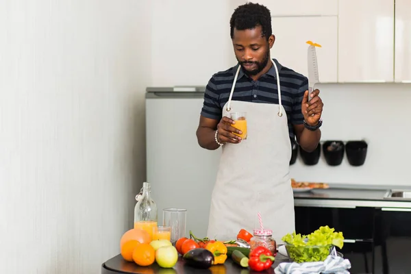 African man preparing healthy food at home in kitchen