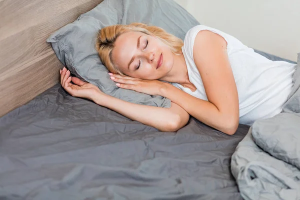 Young woman sleeping in bed