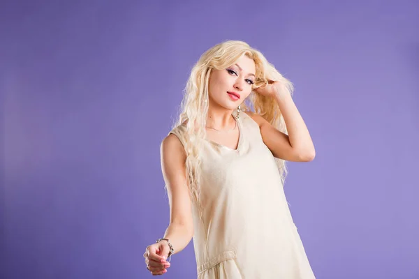 Lächeln schöne blonde Frau auf violettem Hintergrund — Stockfoto