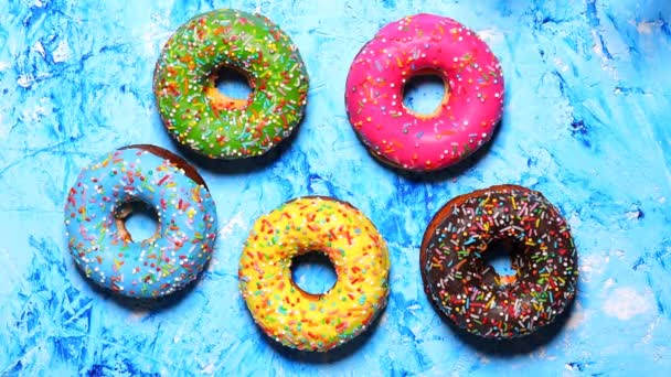 Woman Hand Picks Table Colorful Sweet Fresh Donuts Blue Background — Stock Video