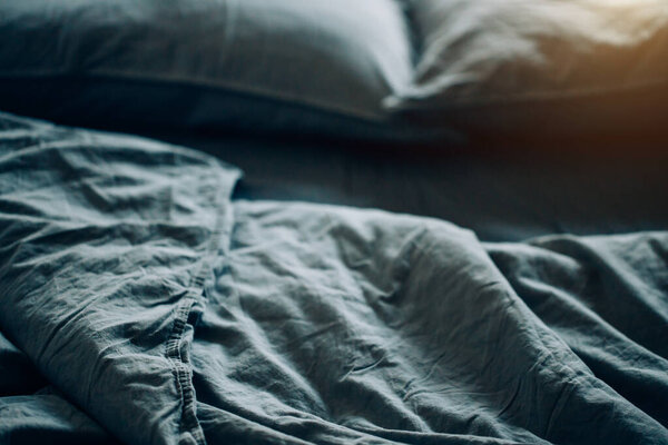Blue bed sheets and pillows after night's sleep.