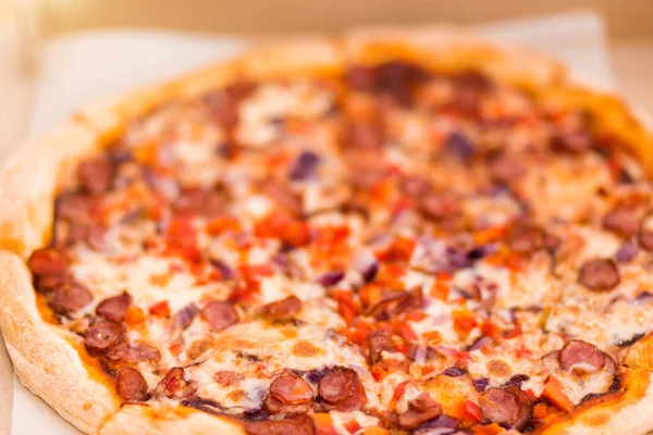 Yakın plan lezzetli taze pizza sosis, biber ve domatesler kutunun içinde. — Stok fotoğraf
