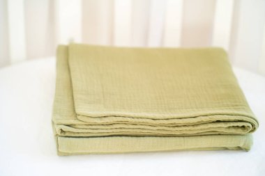 Beyaz arka planda güzel bir zeytin yeşili bebek battaniyesi.