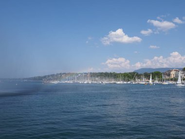 Rainbow and yachts at swiss Leman Lake landscapes at european Geneva city promenade in Switzerland with clear blue sky in 2018 warm sunny summer day on August.