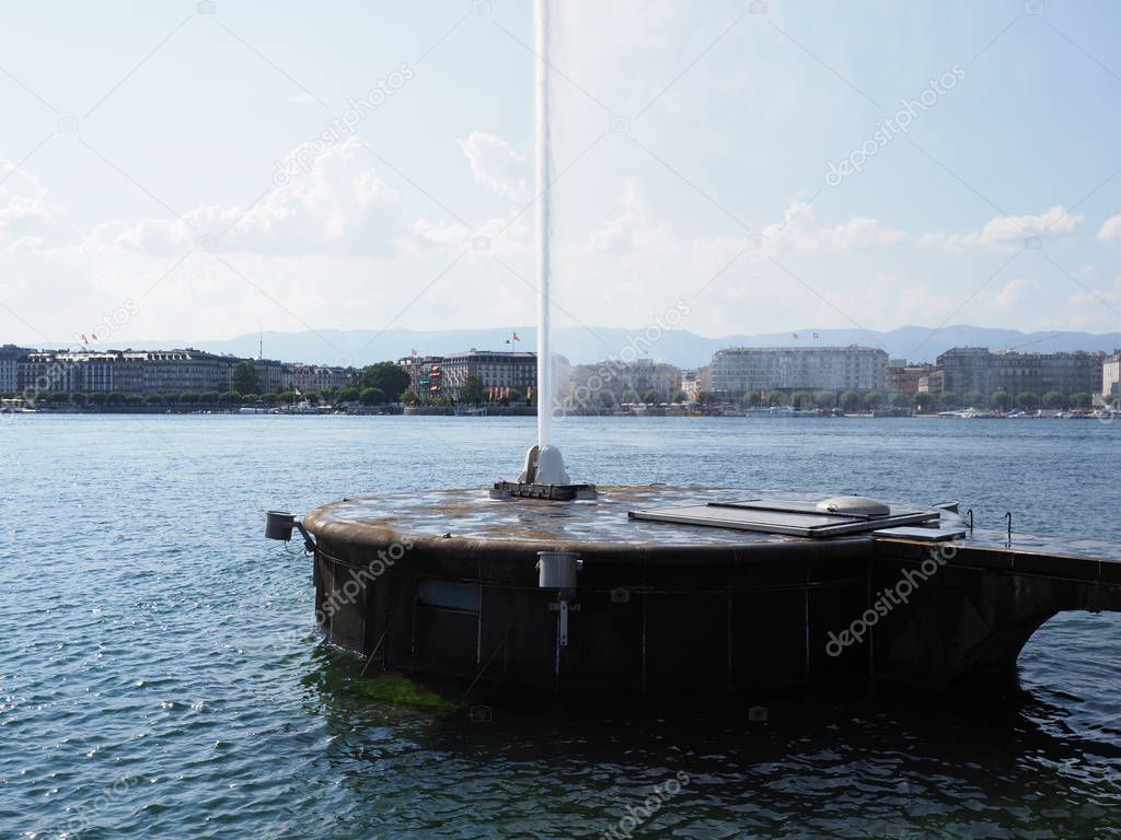 Highest in the world water jet at Swiss alpine Lake Geneva landscapes with view on european city in SWITZERLAND seen from promenade with clear blue sky in 2018 warm sunny summer day on August.
