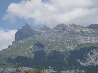 High mountains range landscapes of french ALPS seen from european Chamonix Mont Blanc town in France with cloudy sky in 2018 warm summer day.