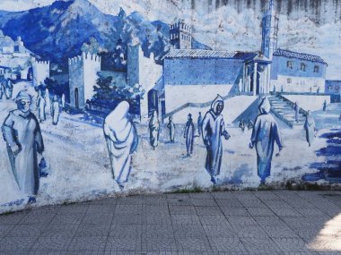 Sıcak güneşli yaz gününde Fas Afrika Chefchaouen kasabasında orta meydanda sokakta duvarda Resim.